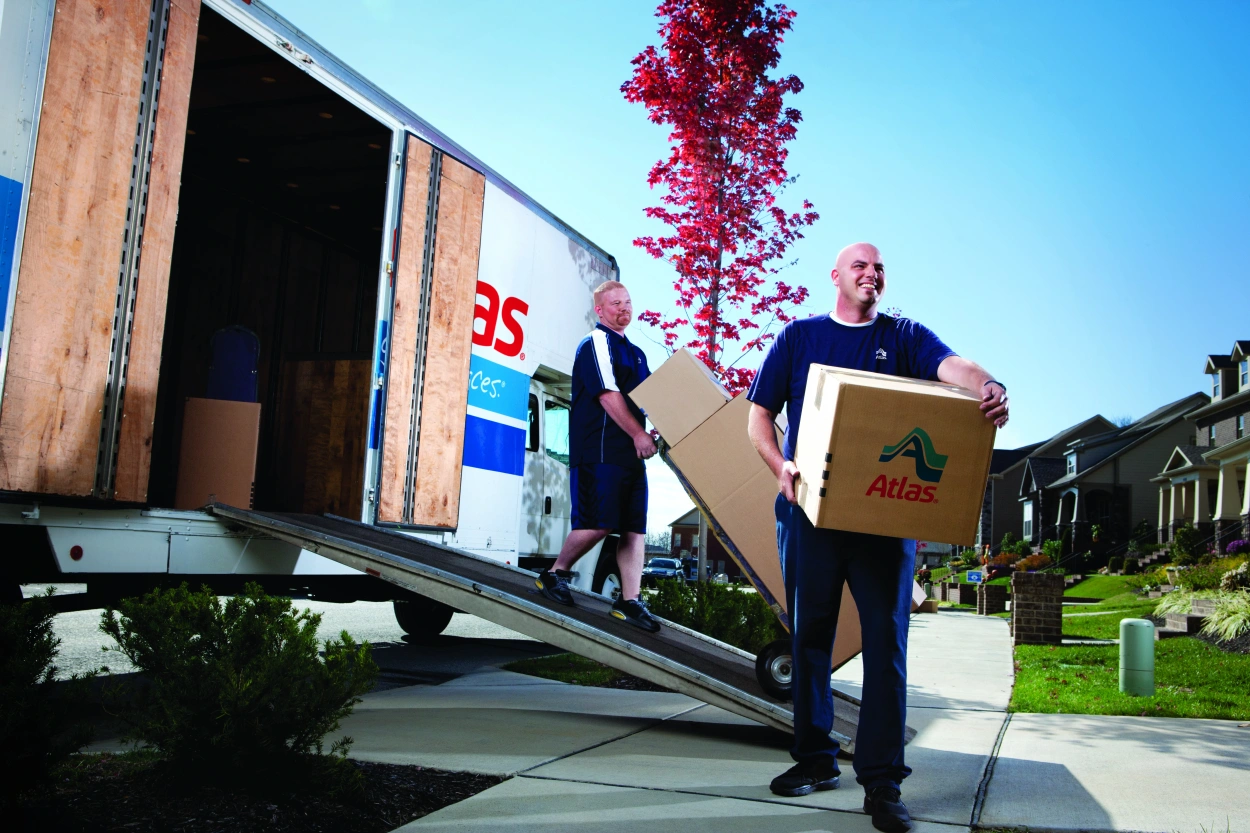 Movers unloading boxes from truck